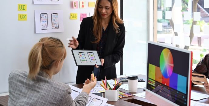 Mobile-app-development-services-app-marketing Two mobile app development company experts brainstorming app marketing ideas