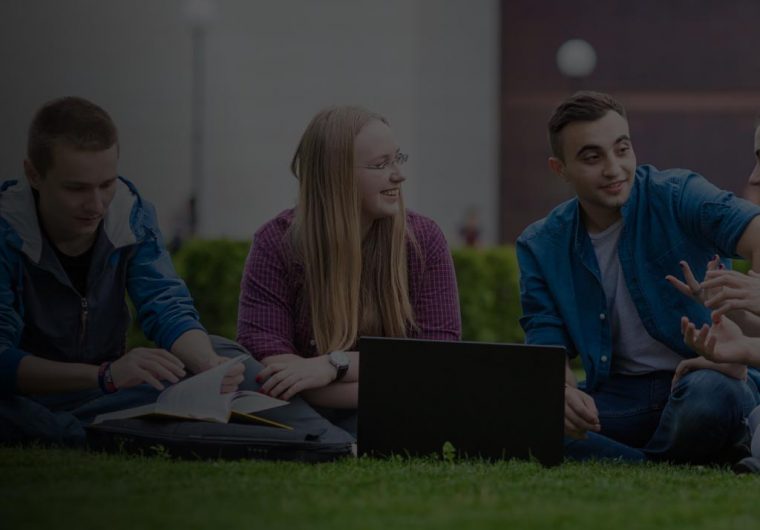 intranet-design-agency-AUBG-portfolio-example Three students sitting on grass and talking in a background image for AUBG