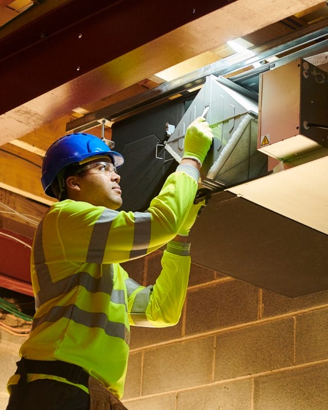smart_academy_image_4 A man in safety gear holds a box