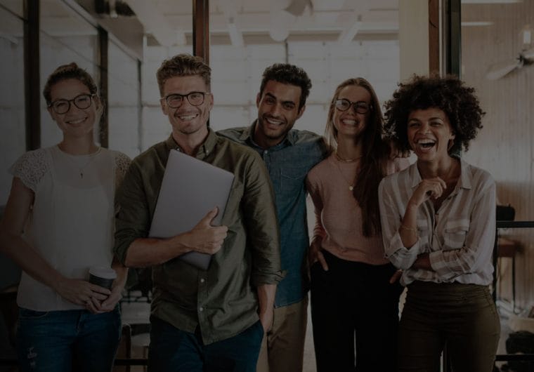 Wodwo-background Five people stand next to each other smiling