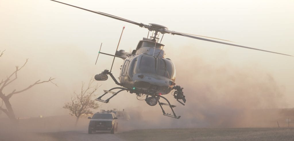 helinet-aviation-backgorund-1 Background image for Helinet Aviation's case study showing a flying helicopter with cars on the road behind it